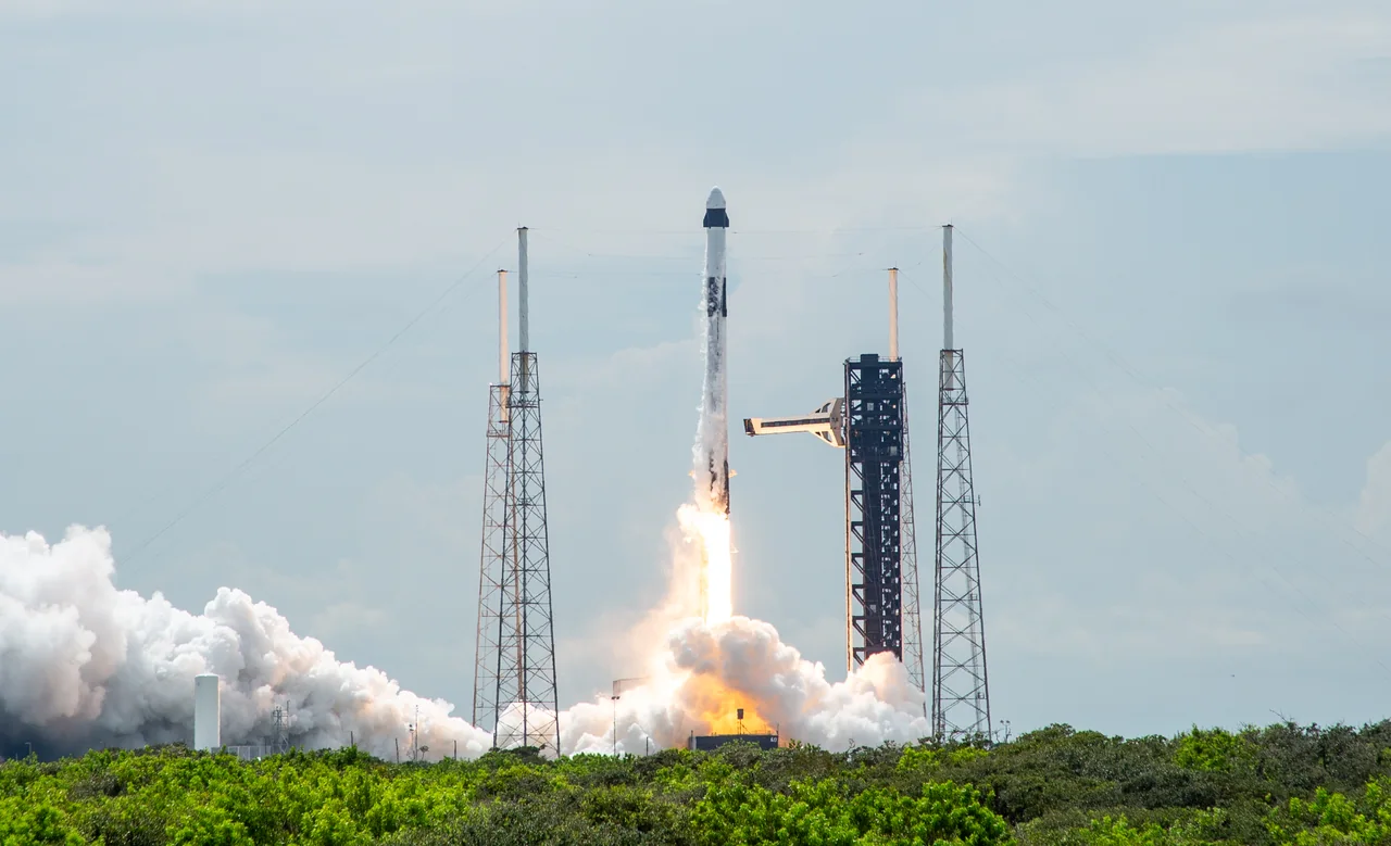 A Falcon 9 carrying Crew-9 lifts off beside the launch tower at Cape Canaveral