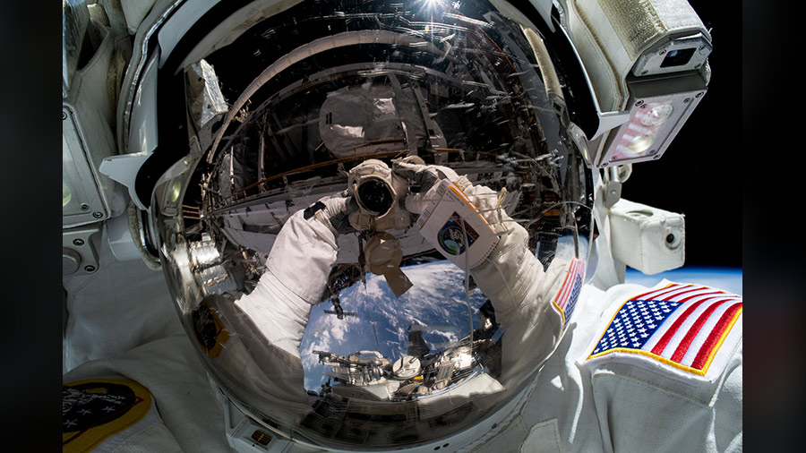 Woody Hoburg takes a self-portrait during a 2023 spacewalk, with Earth reflected in his helmet.