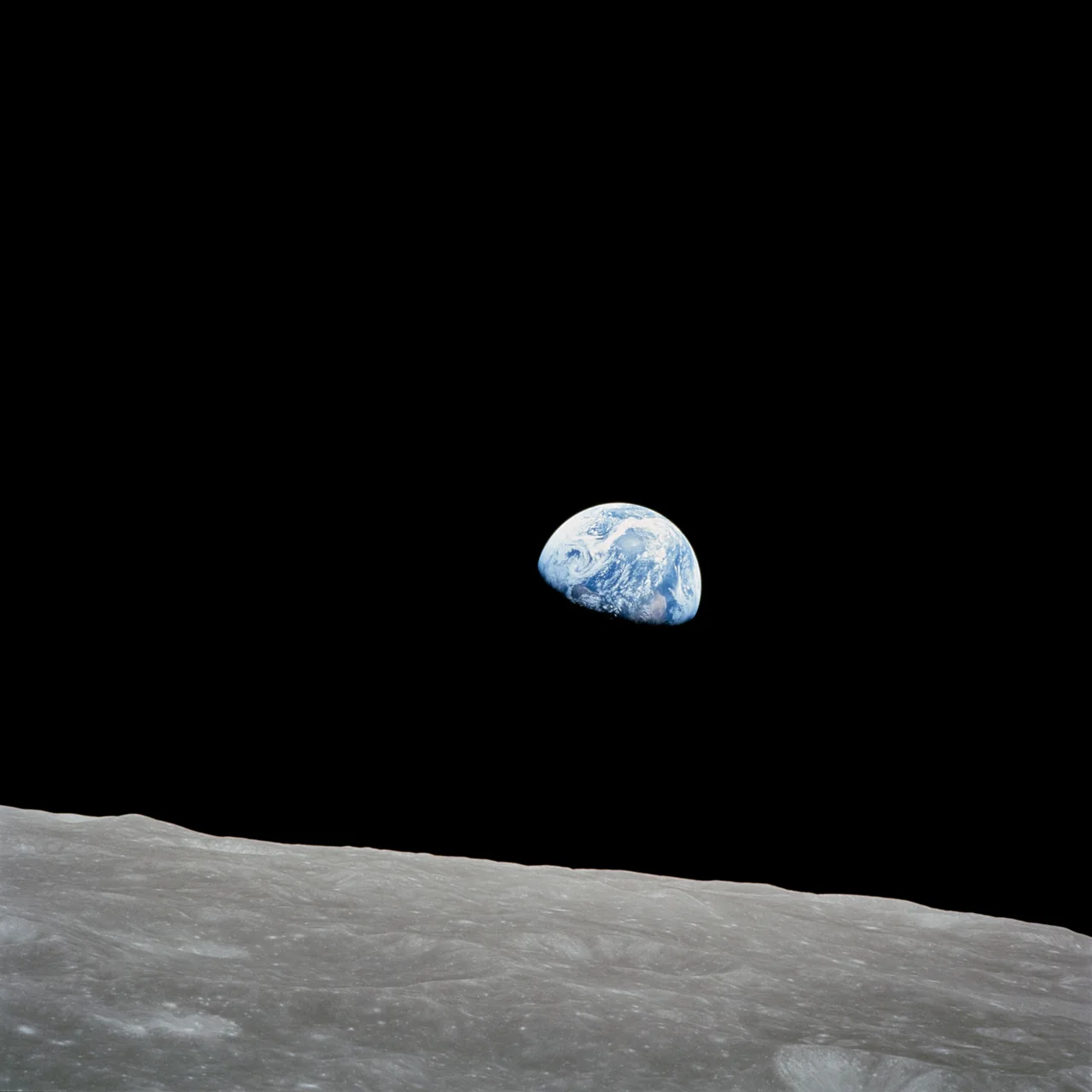 Earth rises above the gray lunar horizon in Bill Anders’s Apollo 8 photograph